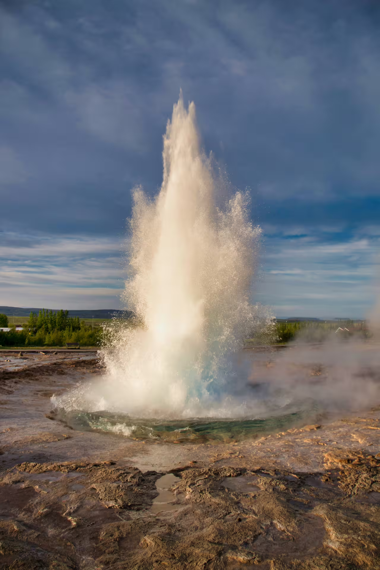 Strokkur geyser erupting on Iceland's Golden Circle route with turquoise water and steam
