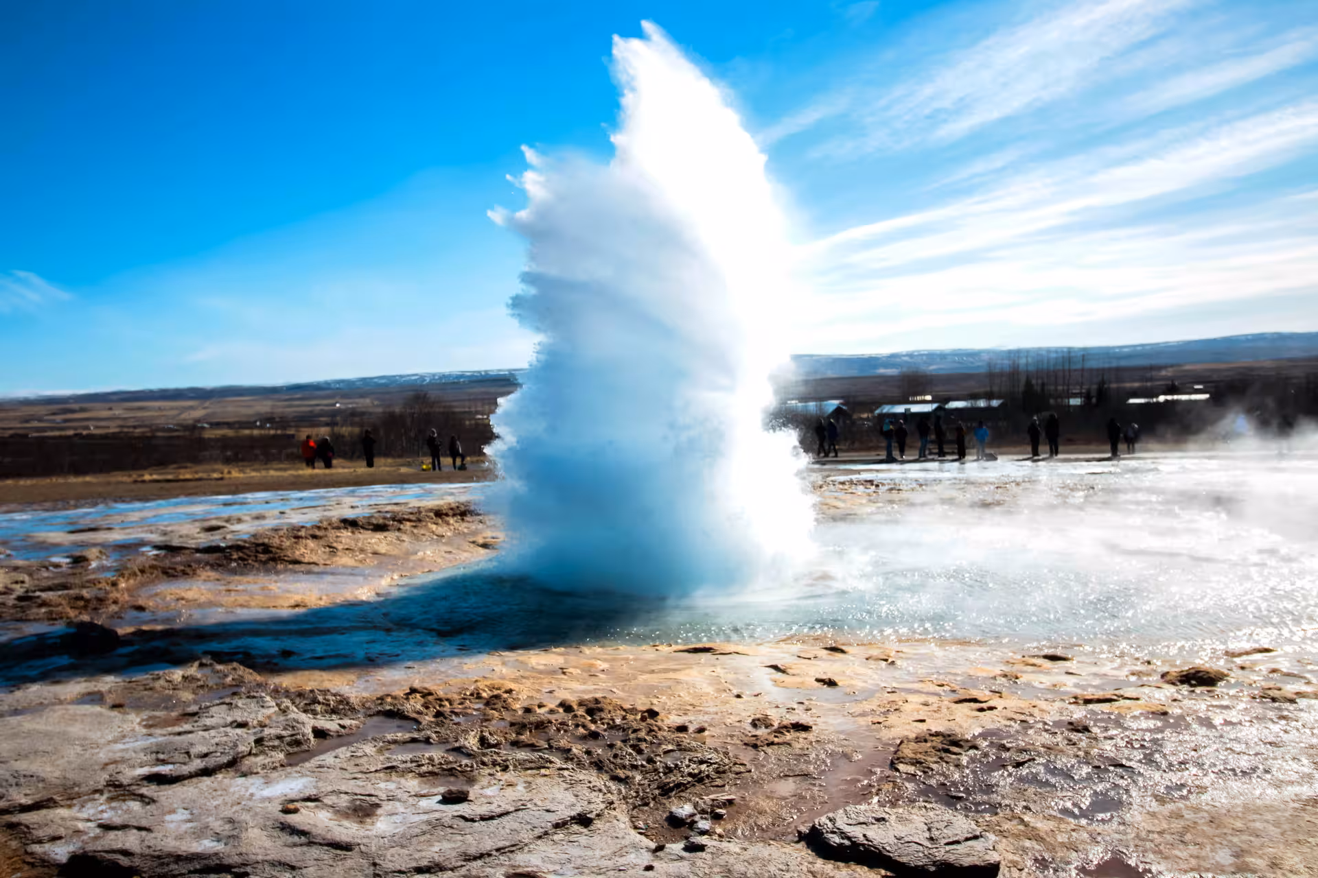 Strokkur geyser blast with visitors at Geysir area, highlight stop on Golden Circle rally car tour