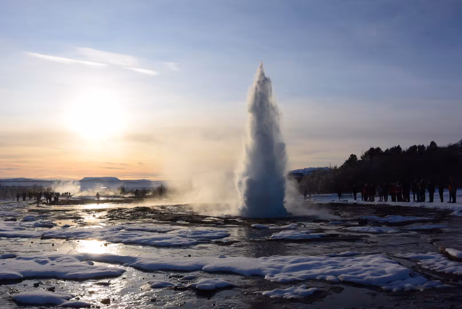 Strokkur geyser erupting at sunset on a Golden Circle private day tour from Reykjavik Iceland in winter
