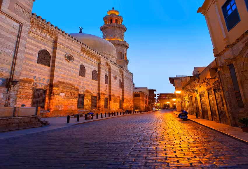 Cobbled street by Sultan Hassan Mosque at dusk, classic stop on a private half-day Old Cairo tour in Cairo