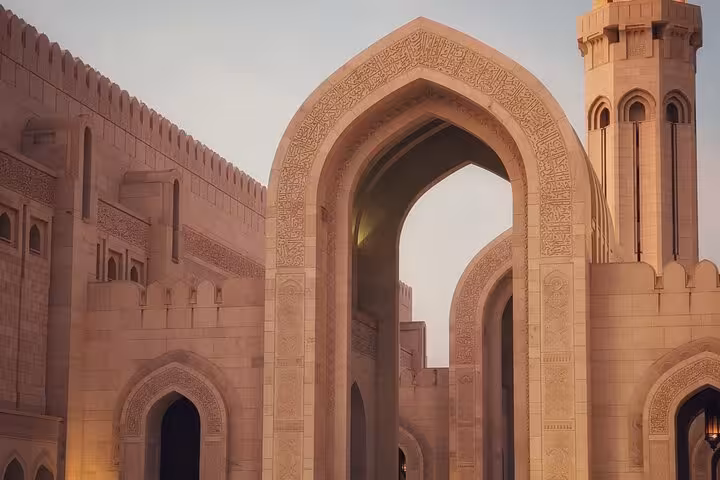 Stunning Islamic architecture of Sultan Qaboos Grand Mosque Muscat featuring ornate arches and minaret