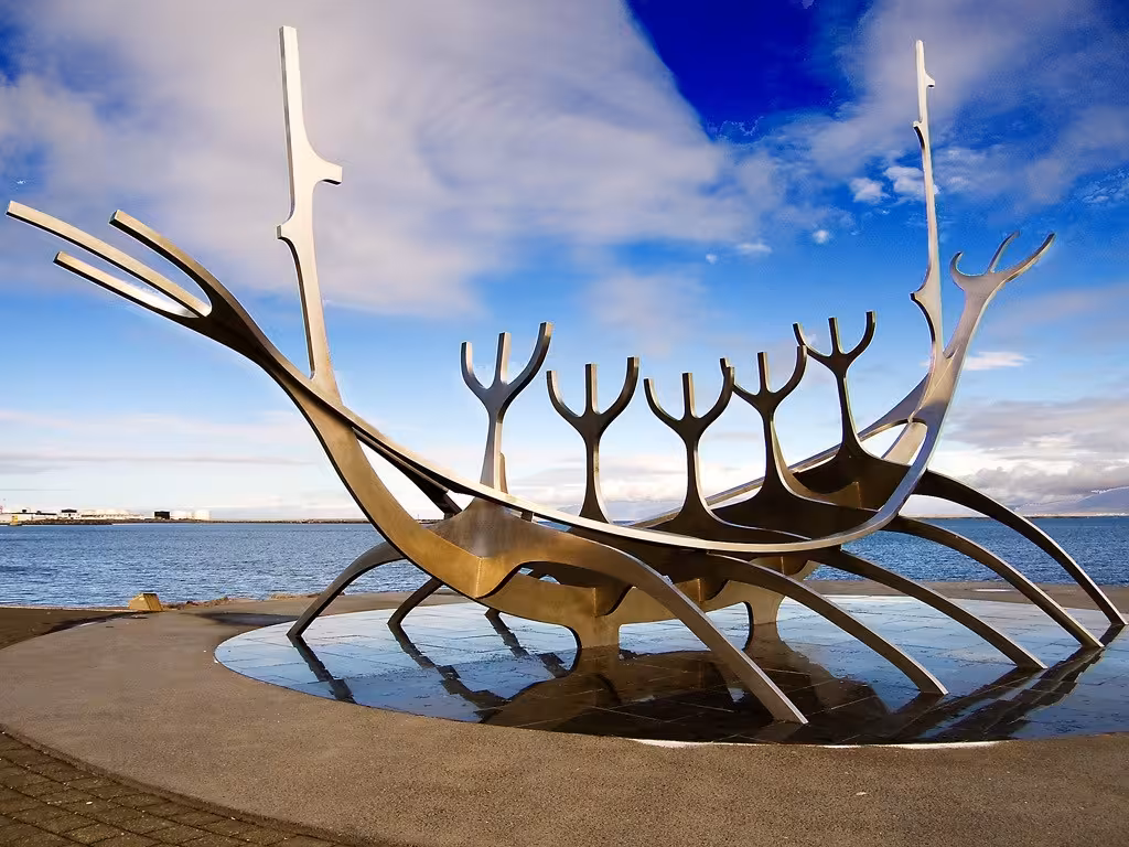 Sun Voyager Viking ship sculpture on Reykjavik waterfront under blue sky, Iceland