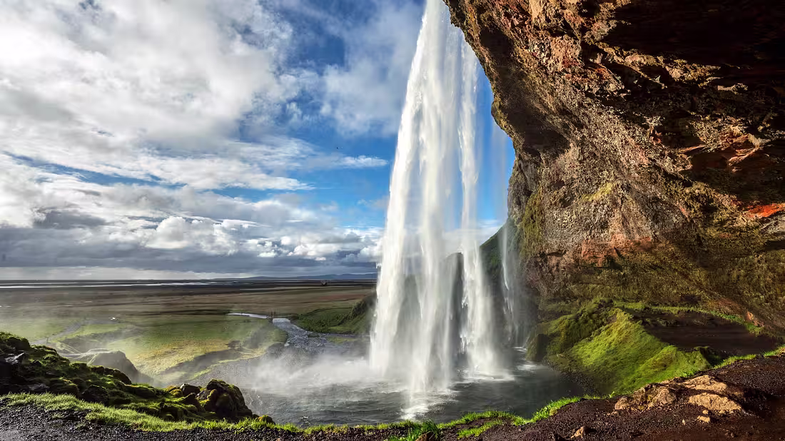 A large waterfall photographed on a sunny summers day