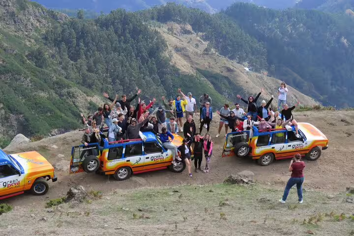 Group enjoying an adventurous off-road tour in colorful jeeps with scenic mountain views on the Sunny Southwest Discovery.