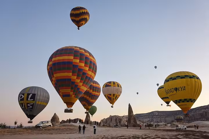 Sunrise hot air balloons over Cappadocia fairy chimneys on a Balloon Tour Cappadocia flight experience