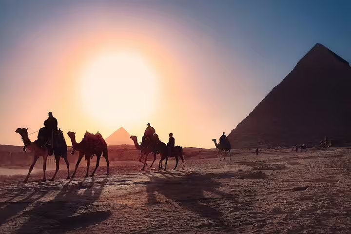 Sunset camel ride at the Giza Pyramids in Cairo, Egypt, iconic desert silhouettes on a private day tour