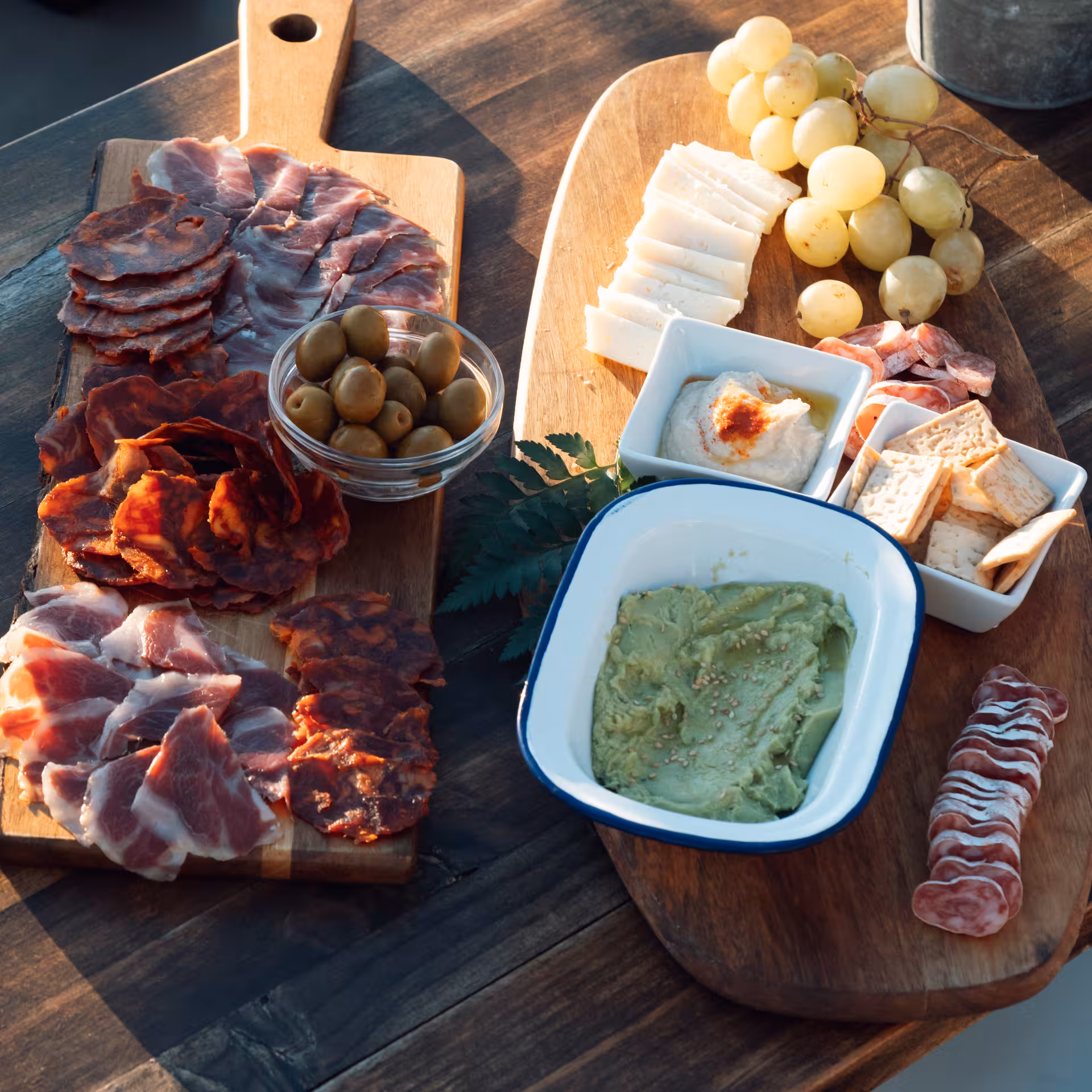 Sunset catamaran cruise tapas spread with cured meats, olives, cheese, grapes and dips served onboard