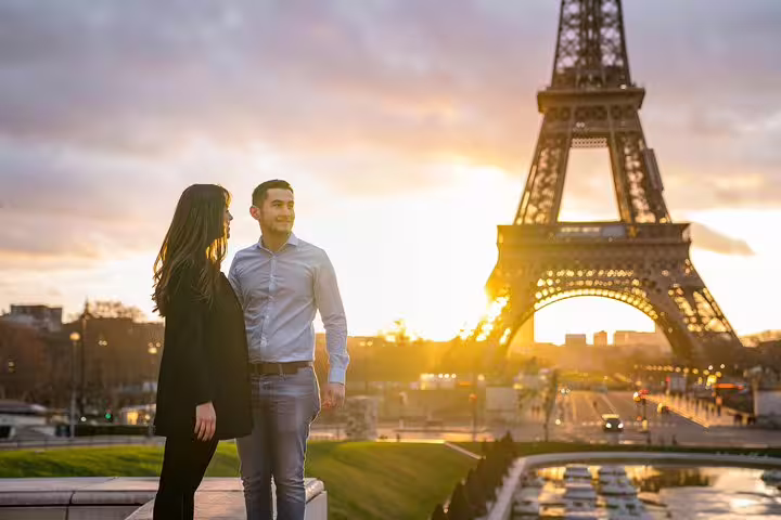 Sunset couple portrait near Eiffel Tower on a private Paris photographer tour, golden hour travel photoshoot