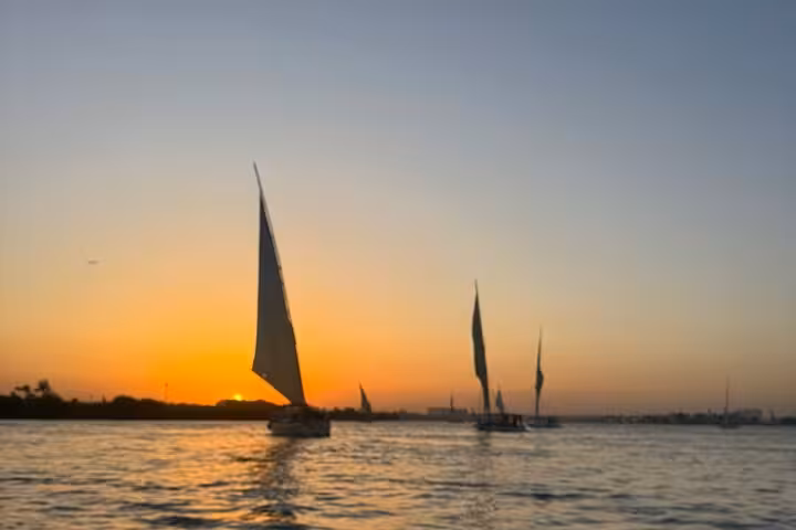 Sunset felucca sail on the Nile River in Cairo with hotel pickup, relaxing cruise and skyline views