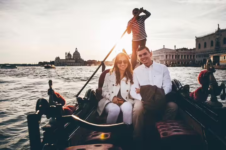 Sunset gondola ride with couple on Grand Canal, perfect for a private Venice travel photographer tour