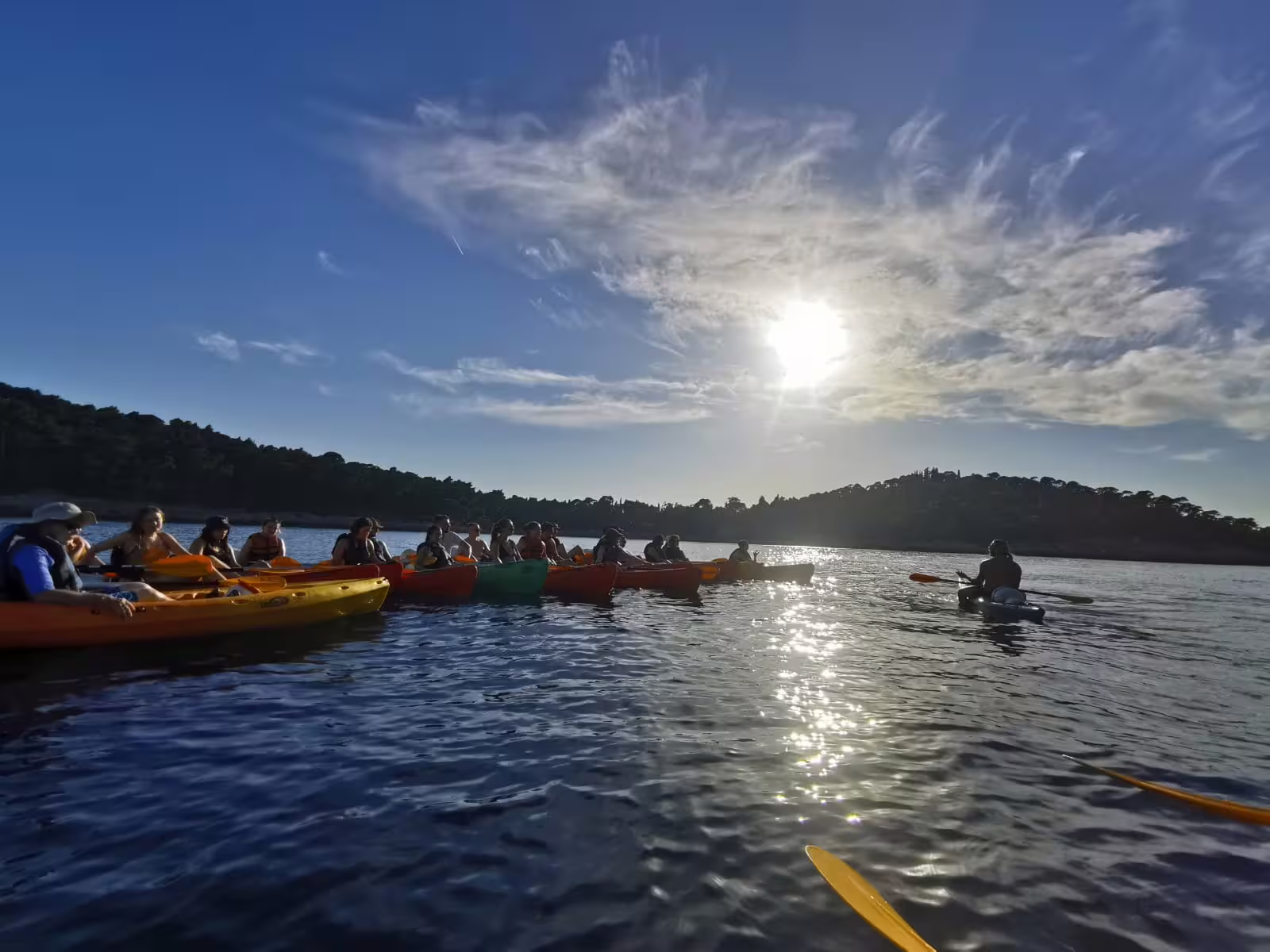 Group sunset kayaking tour on calm Adriatic waters, guided paddle with snorkeling break plus water and wine