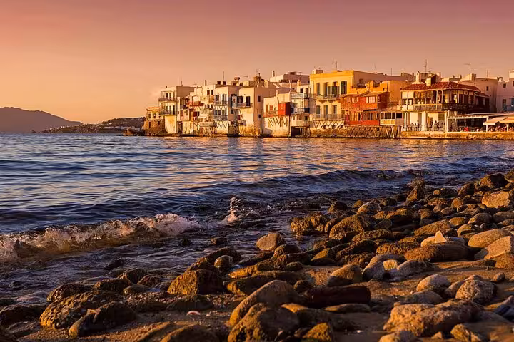 Sunset over Little Venice Mykonos with rocky shoreline, scenic moment on 7-day Athens Mykonos Santorini trip