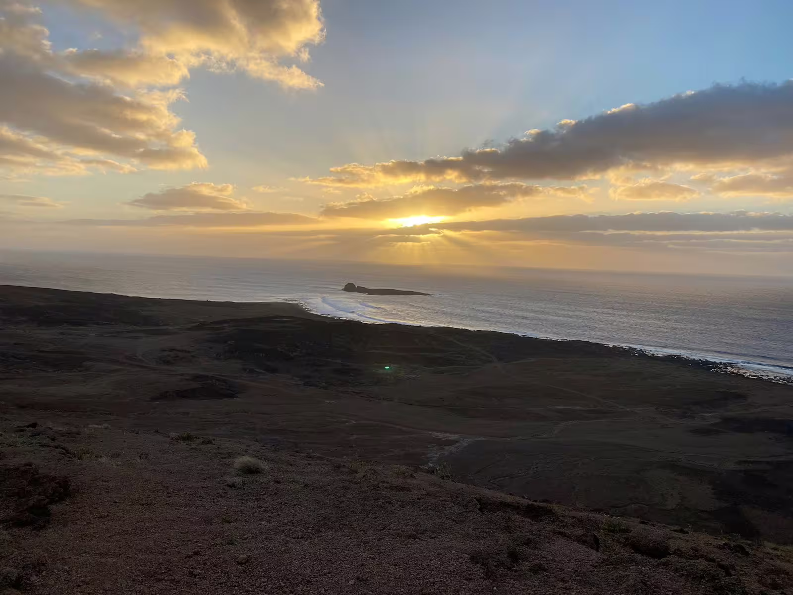 Sunset panorama from Mount Lion summit overlooking the coastline and ocean, ideal for scenic hiking tours
