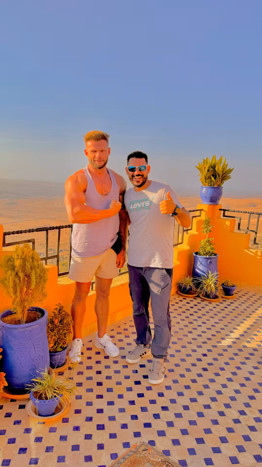 Smiling paraglider in gear ready for an exhilarating flight over the scenic Agafay Desert landscape near Marrakech.