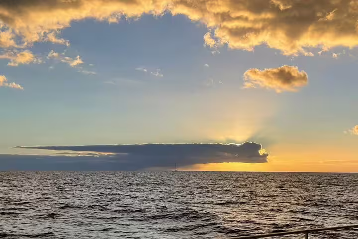 Sunset view over the ocean during a full day private sailing cruise, showcasing serene waters and a vibrant sky.