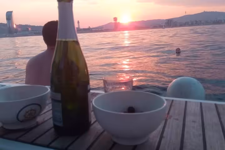 Sunset sailing in Barcelona with cava from the open bar and snacks on deck during a 1-hour cruise