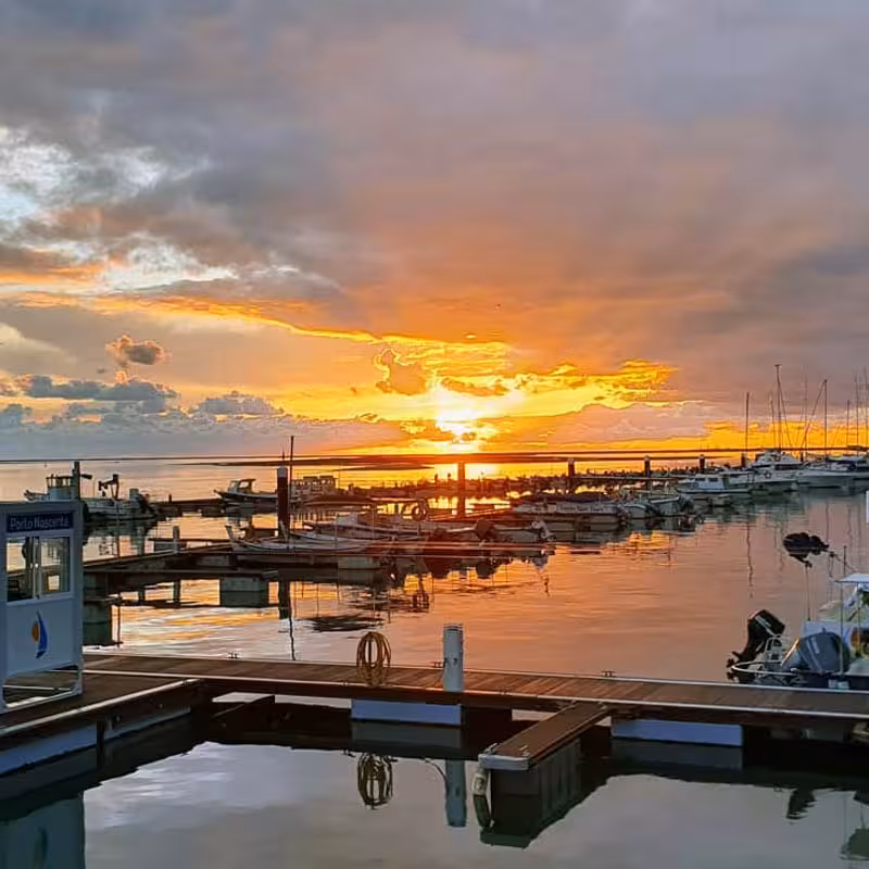 Scenic marina at sunset with vibrant skies and tranquil waters, ideal for Sunset Tour Privado bookings.