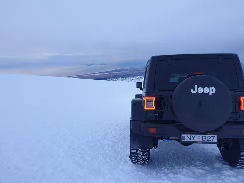 Black Jeep Wrangler on Eyjafjallajokull glacier snowfield in Iceland with snowy landscape