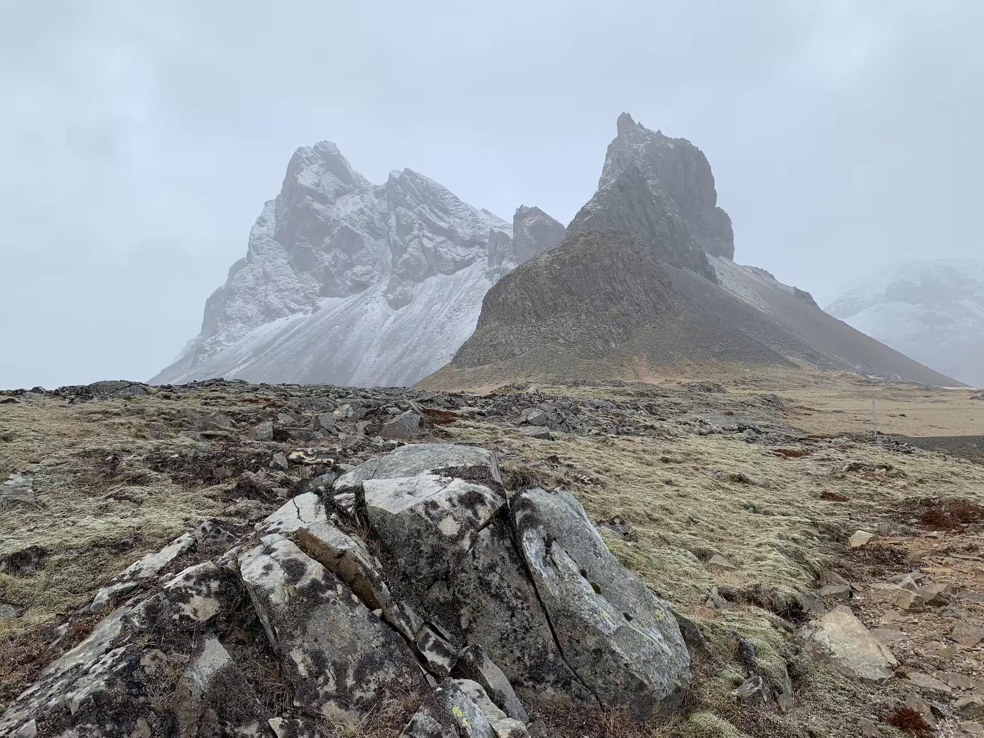 Dramatic jagged mountain peaks with snow and misty clouds on a private super jeep tour in Iceland