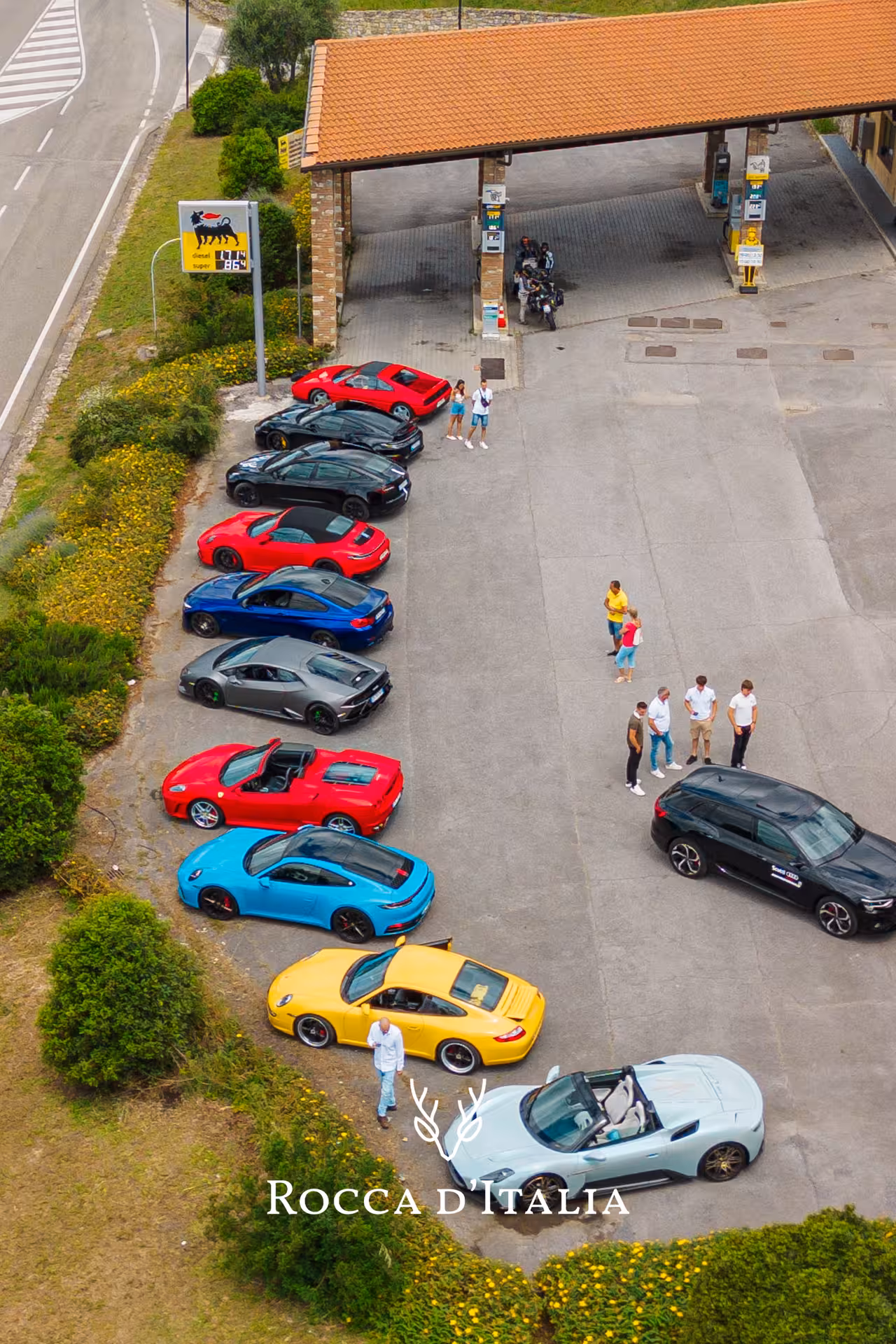 Colorful supercars lined up at Italian gas station during private tour in Tuscany, Italy