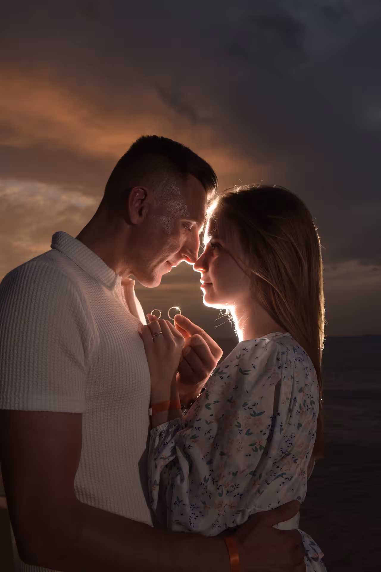 Couple shares an intimate moment at sunset during a surprise proposal photoshoot at Heraklion Venetian Port.
