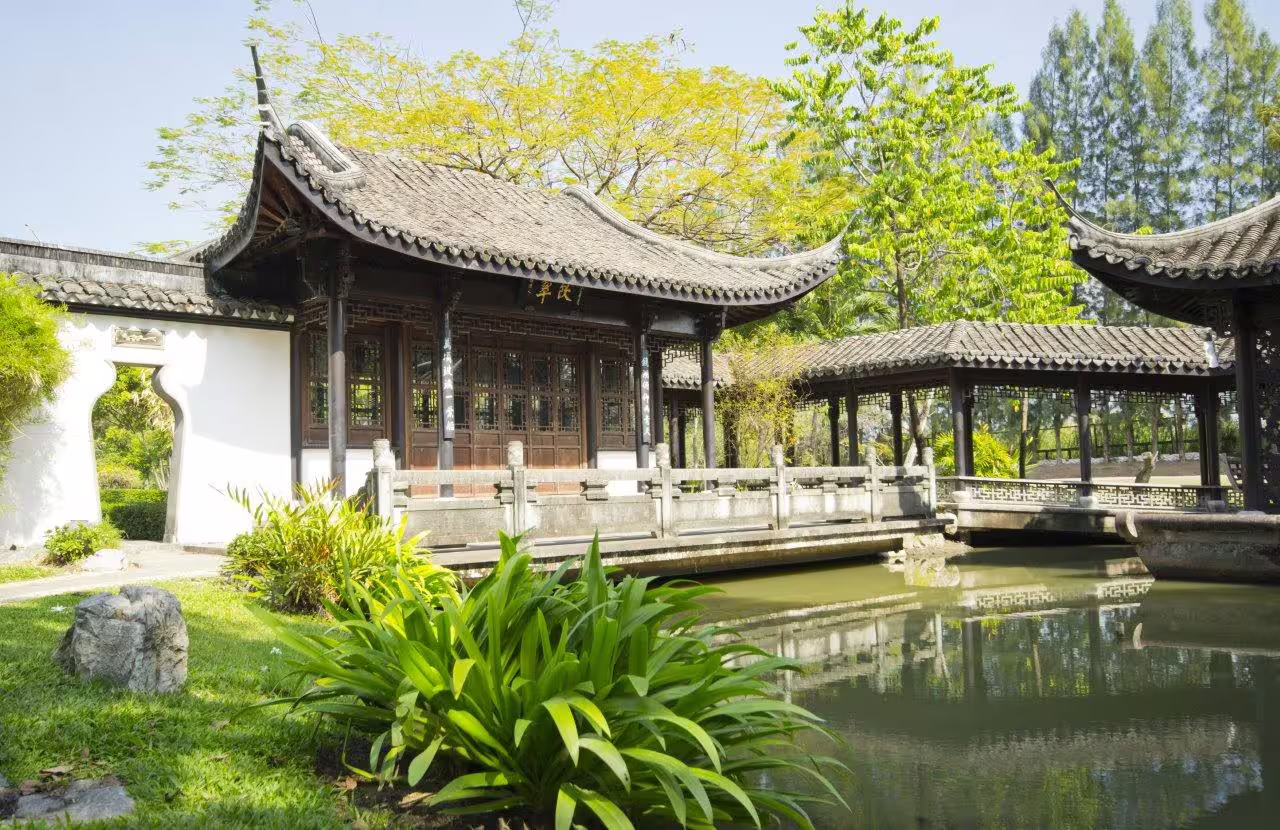 Explore serene traditional Chinese architecture and lush gardens on a Suzhou private city tour, featuring tranquil ponds.