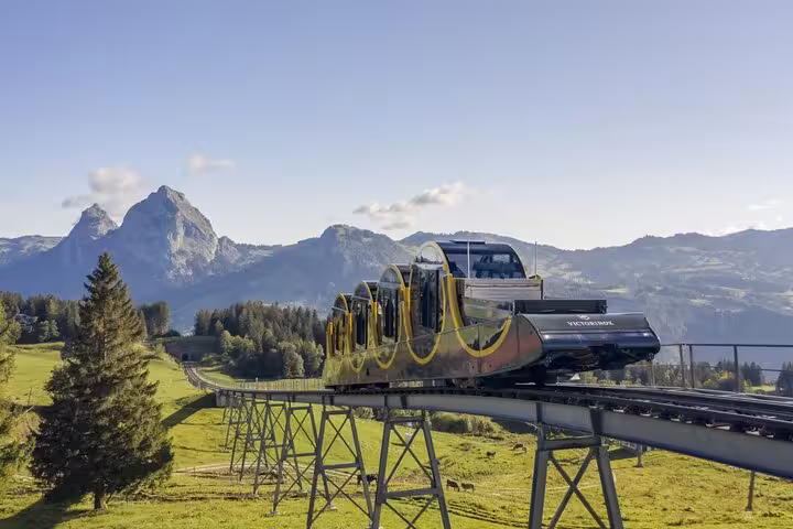 Modern cable car gliding through Swiss Alps with stunning mountain backdrop, a highlight of Swiss adventures.