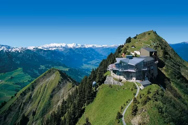 Panoramic view of the Swiss Alps from a mountaintop restaurant on a Swiss Travel Pass customizable itinerary tour.