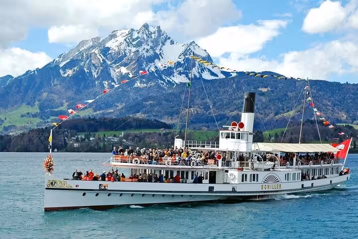 Scenic Swiss steamboat cruise on Lake Lucerne with snow-capped mountains, perfect for a customizable itinerary tour.
