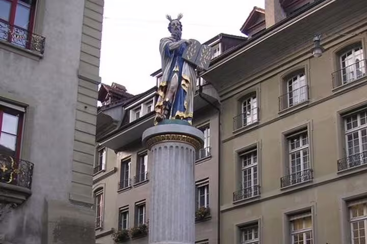 Colorful statue of Moses on a column pillar in a historic Swiss town square