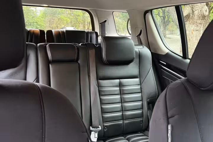 Luxurious black leather interior of a private tour vehicle in Sydney, offering comfortable seating.