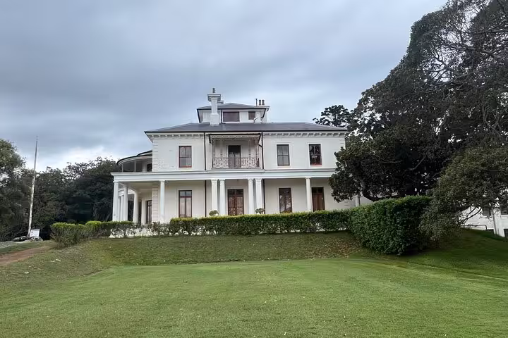 Elegant Victorian-style mansion in Sydney, showcasing classic architecture and manicured gardens on a private tour.