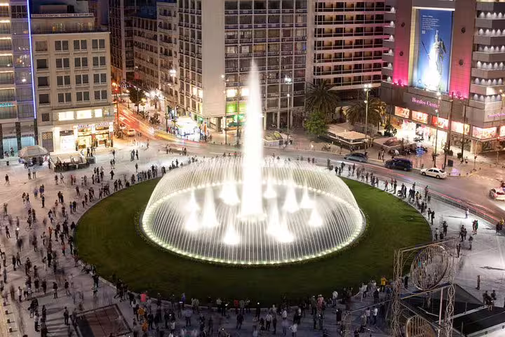 Syntagma Square fountain at night in central Athens, a key photo stop on a private half-day highlights tour