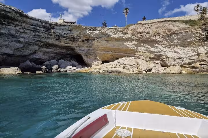 Stunning sea cave exploration by boat in Syracuse with turquoise waters and dramatic coastal cliffs