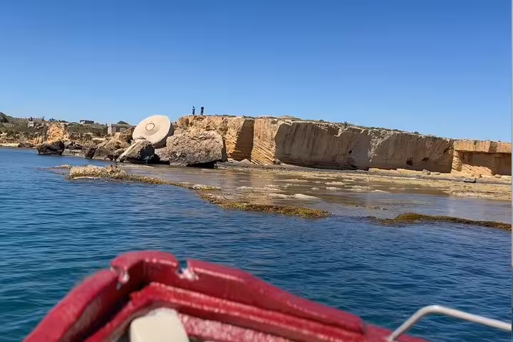 Private boat tour near Syracuse sea caves with ancient limestone rocks and crystal-clear blue water