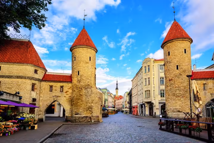 Viru Gate medieval stone towers with red rooftops on cobblestone street in Tallinn Old Town