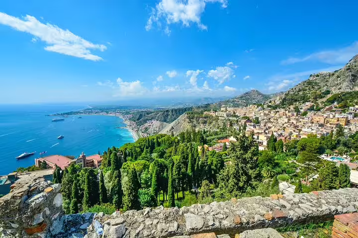 Panoramic view of Taormina’s coastline, lush gardens and historic hilltop town on a 2-hour private sightseeing tour in Sicily
