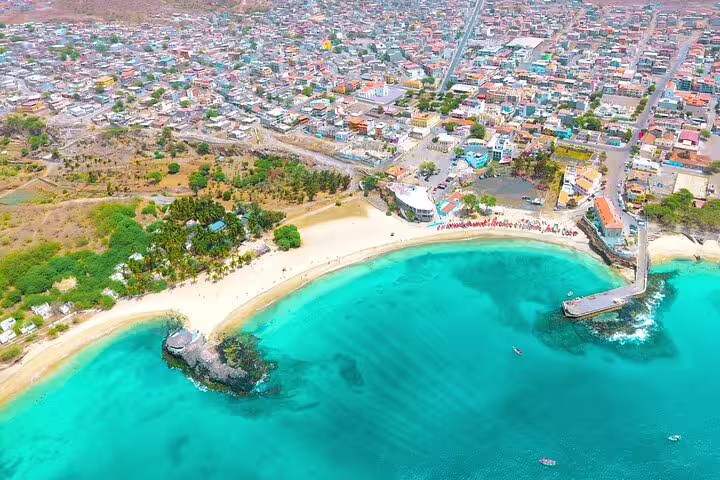 Aerial view of Tarrafal Beach on Santiago Island, featuring turquoise waters and scenic coastal landscape.