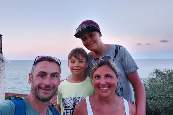 Group selfie by the Mediterranean at sunset during a Tarragona self-guided scavenger hunt and city tour
