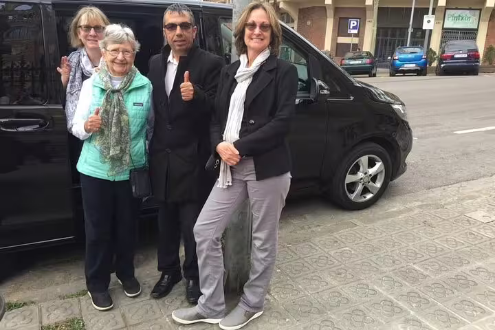 Friendly tour group ready to explore Tarragona's historical sites, posing happily by their comfortable transport vehicle.