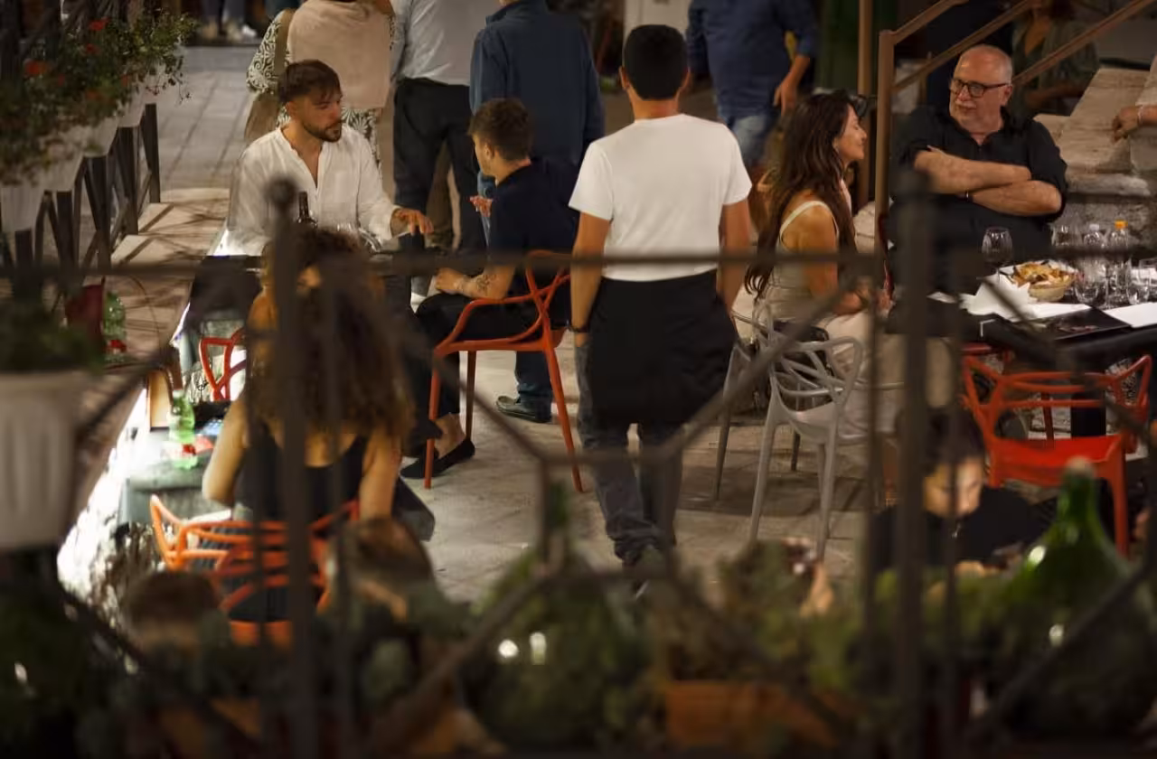 Evening trattoria scene after Taurasi DOCG tasting, enjoying local delights and Campania food pairing