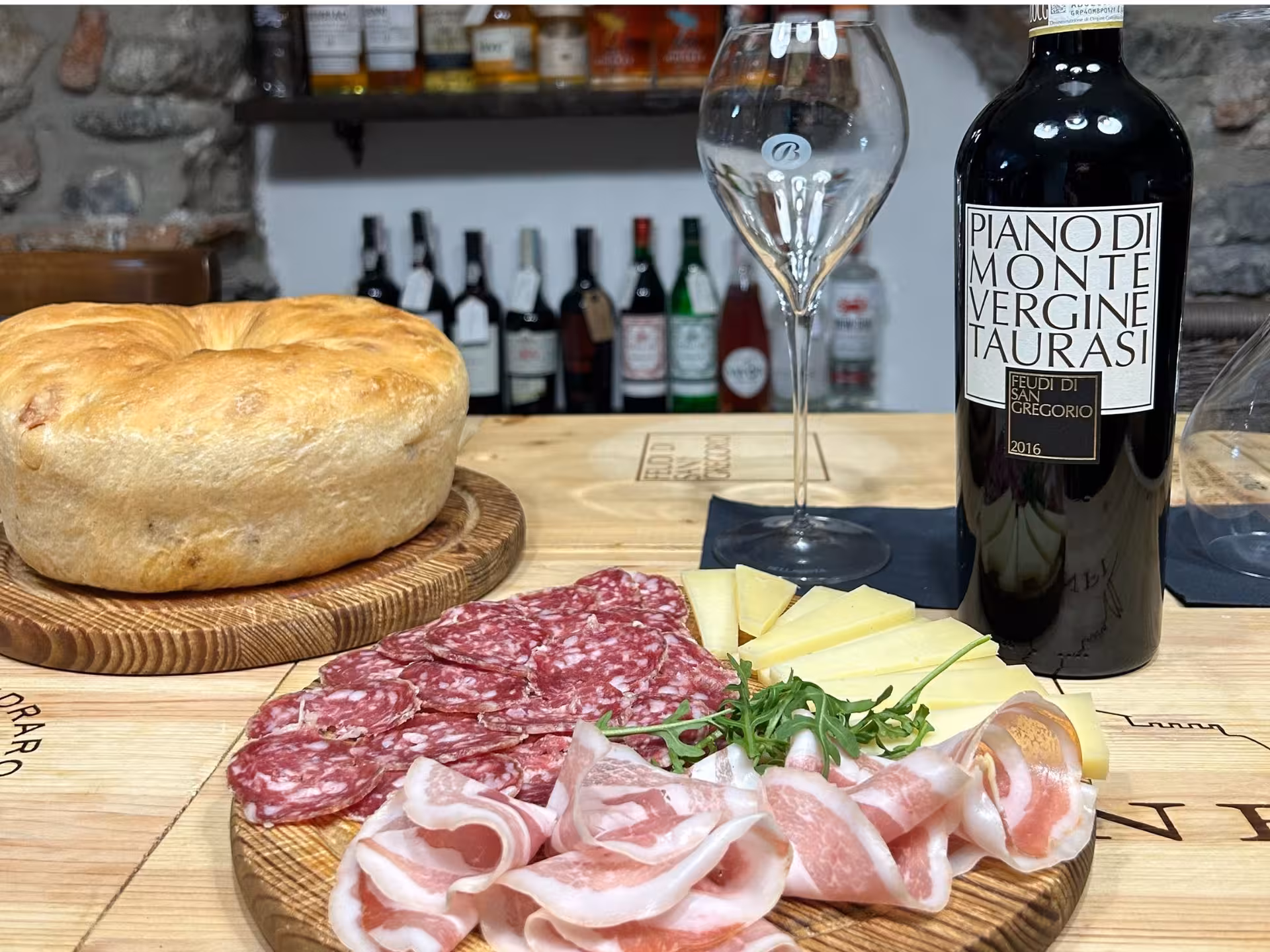 Taurasi wine paired with Italian charcuterie and cheese at a Lake Como tasting experience.