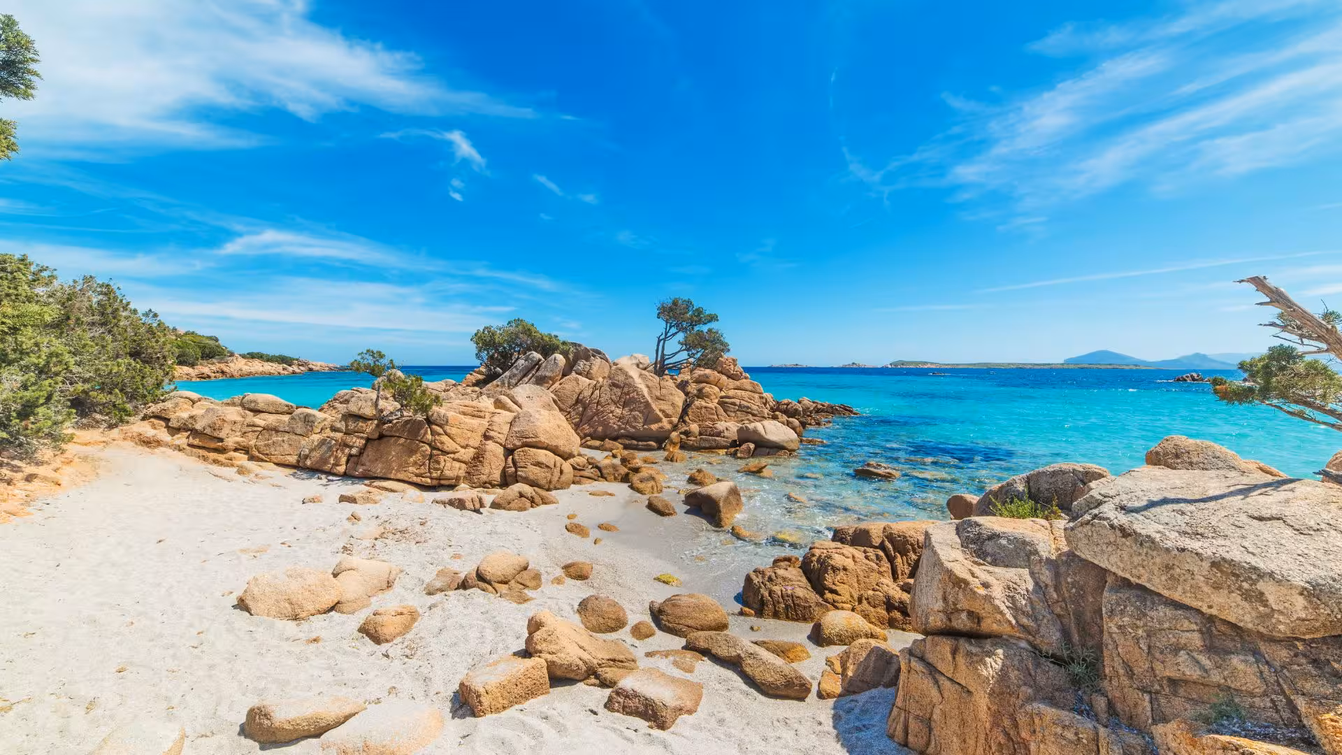 Scenic coastal landscape of Tavolara with rugged rocks and azure sea, ideal for exploring on a private dinghy tour.