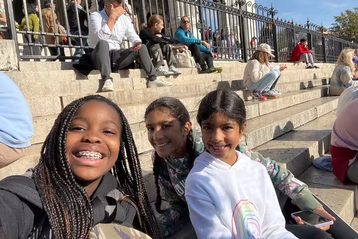 Teens taking a selfie on Sacré-Cœur steps in Montmartre, Paris, on a self-guided scavenger hunt tour
