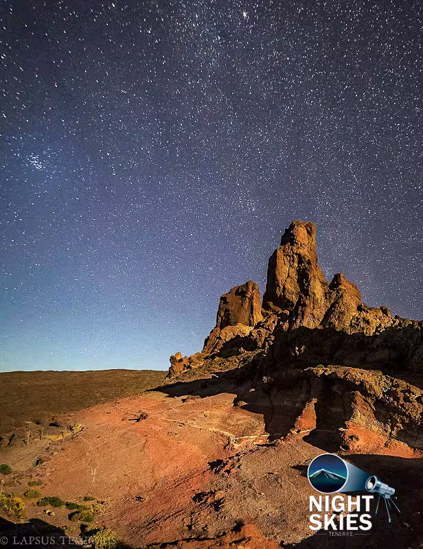 Starry night sky over rocky terrain in Tenerife, perfect for stargazing on a 5-star safari tour.