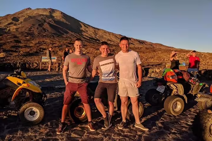 Group of friends enjoying a Teide Sunset Quad Trip with vibrant sunset and mountain backdrop.