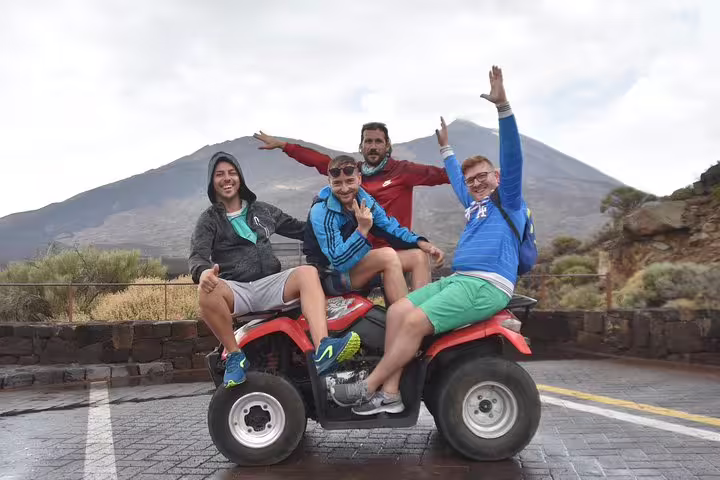 Group of friends enjoying a quad biking tour at Teide Volcano National Park with scenic views in the background.