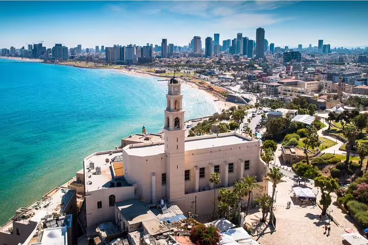 Aerial view of Old Jaffa church tower with Tel Aviv skyline and Mediterranean beach coastline