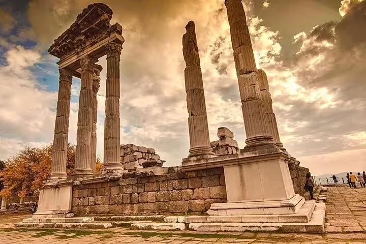 Marvel at the grand columns of the Temple of Athena in Pergamon under a dramatic sky on the Revelation Tour.