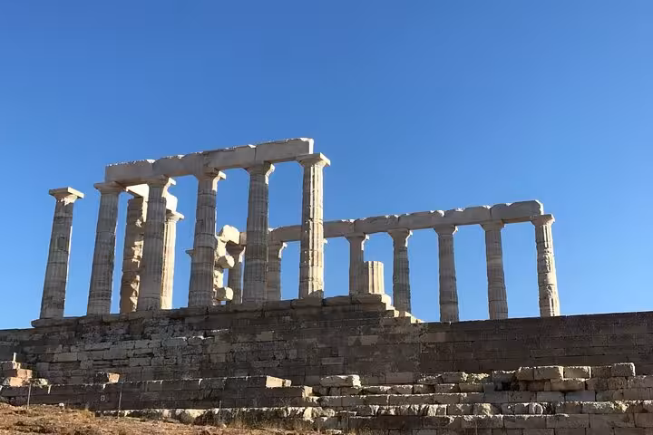 Majestic view of the ancient Temple of Poseidon ruins under a clear blue sky at Cape Sounio.
